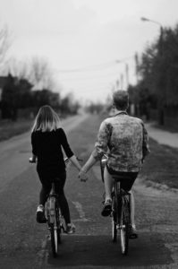 Couple riding on a bike trail together - Cheap Date Ideas
