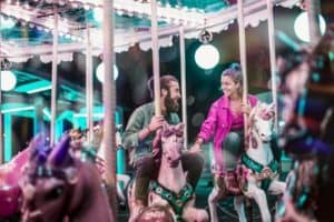 Couple on a carousel ride together - Cheap Date Ideas