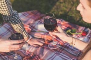 Couple drinking wine during picnic - Cheap Date Ideas