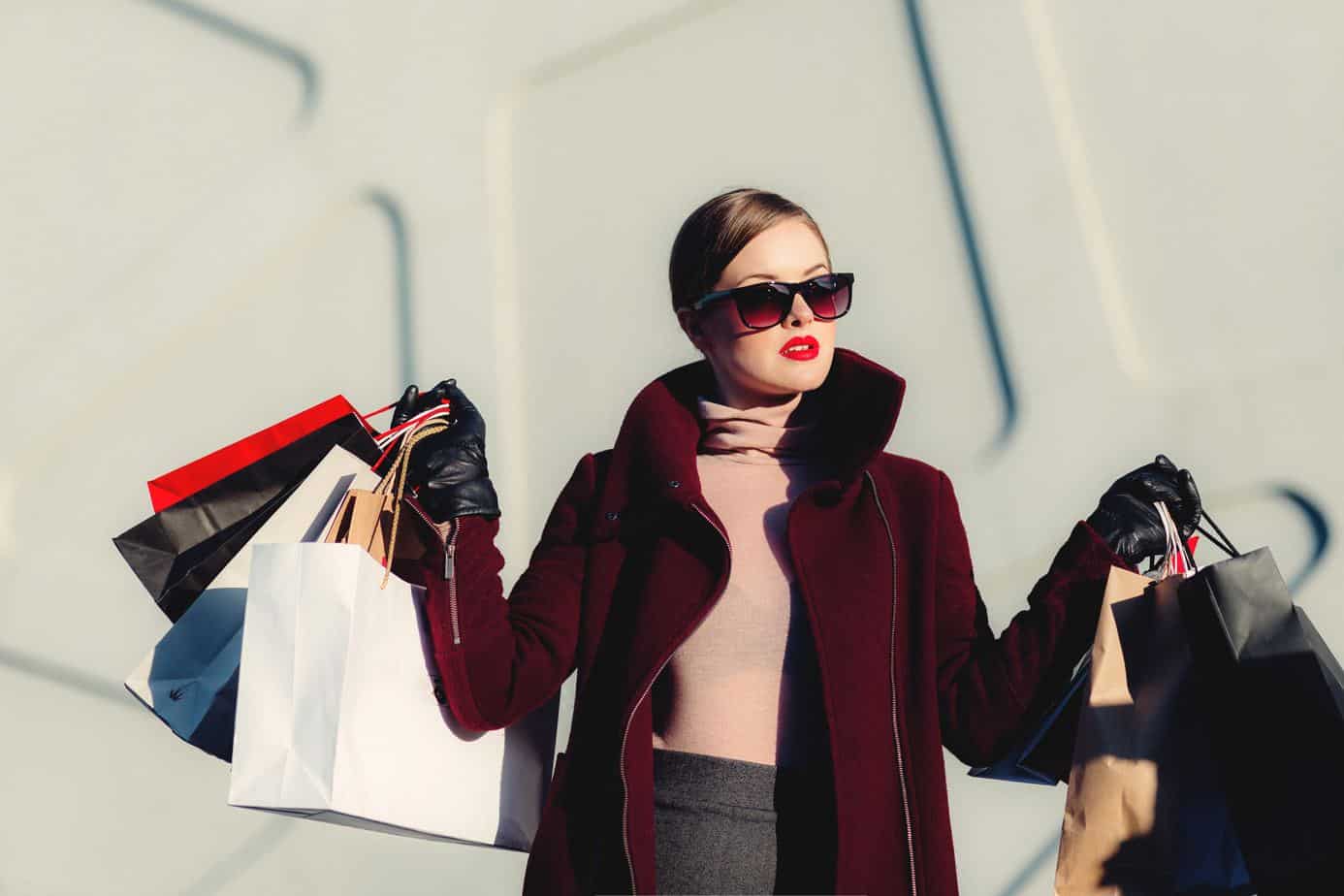 woman shopping for clothing - things to stop buying to save money