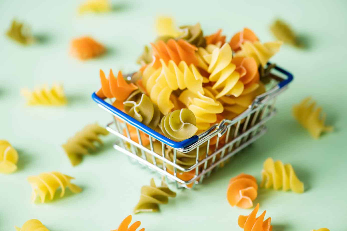 pasta in a small shopping basket - buy in bulk - how to save on groceries