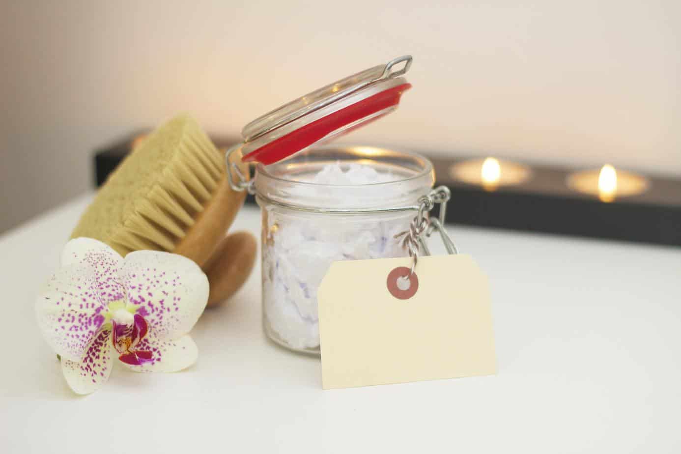 sugar scrub, candles and orchid on table - for a no spend challenge