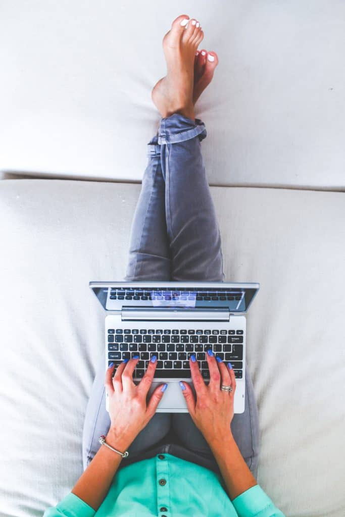 woman on laptop in bed - working from home