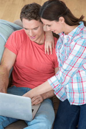 husband and wife doing finances on laptop