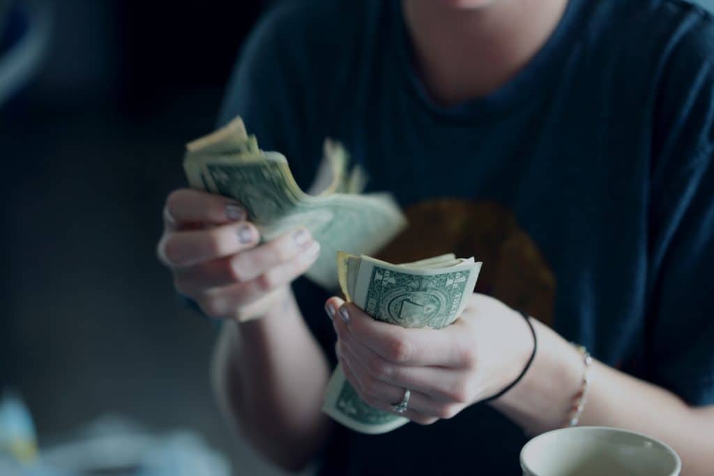 woman checking money in hands