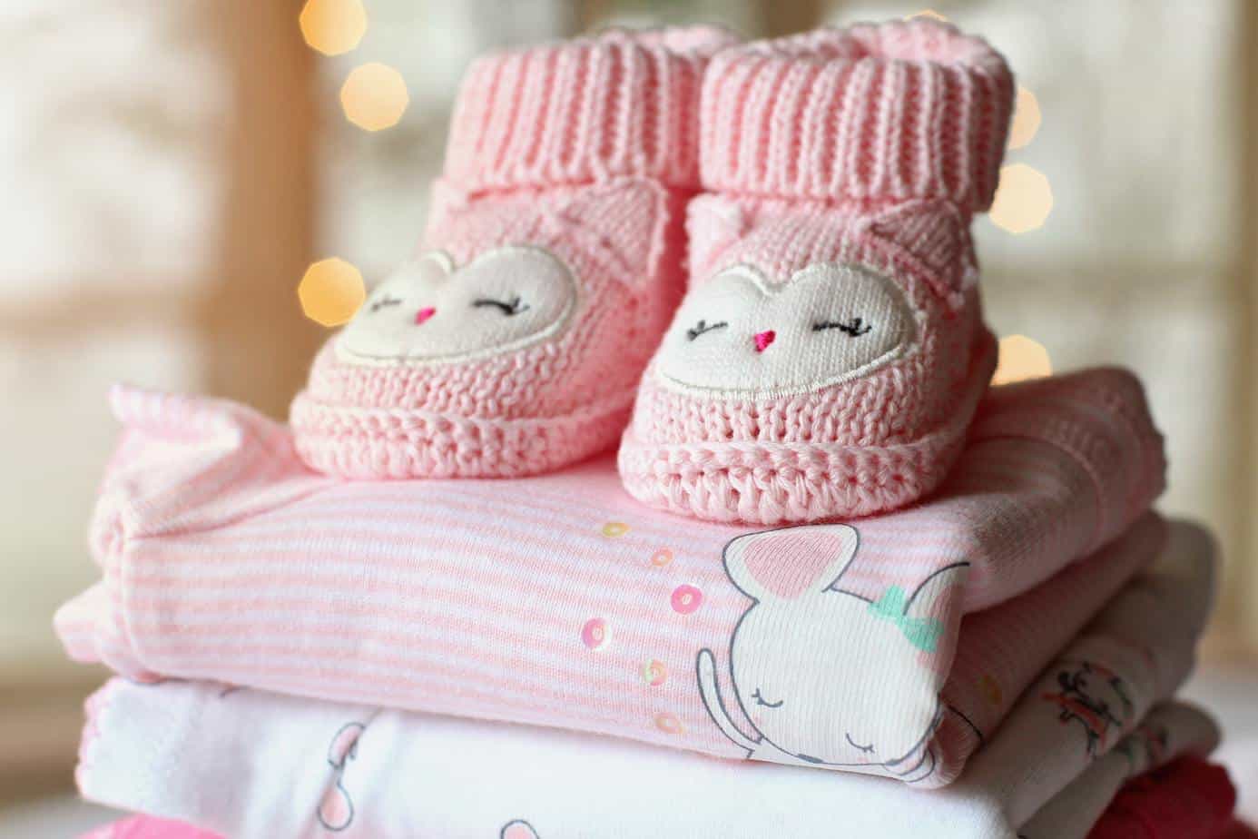 baby freebies today - pink booties on folded baby clothes