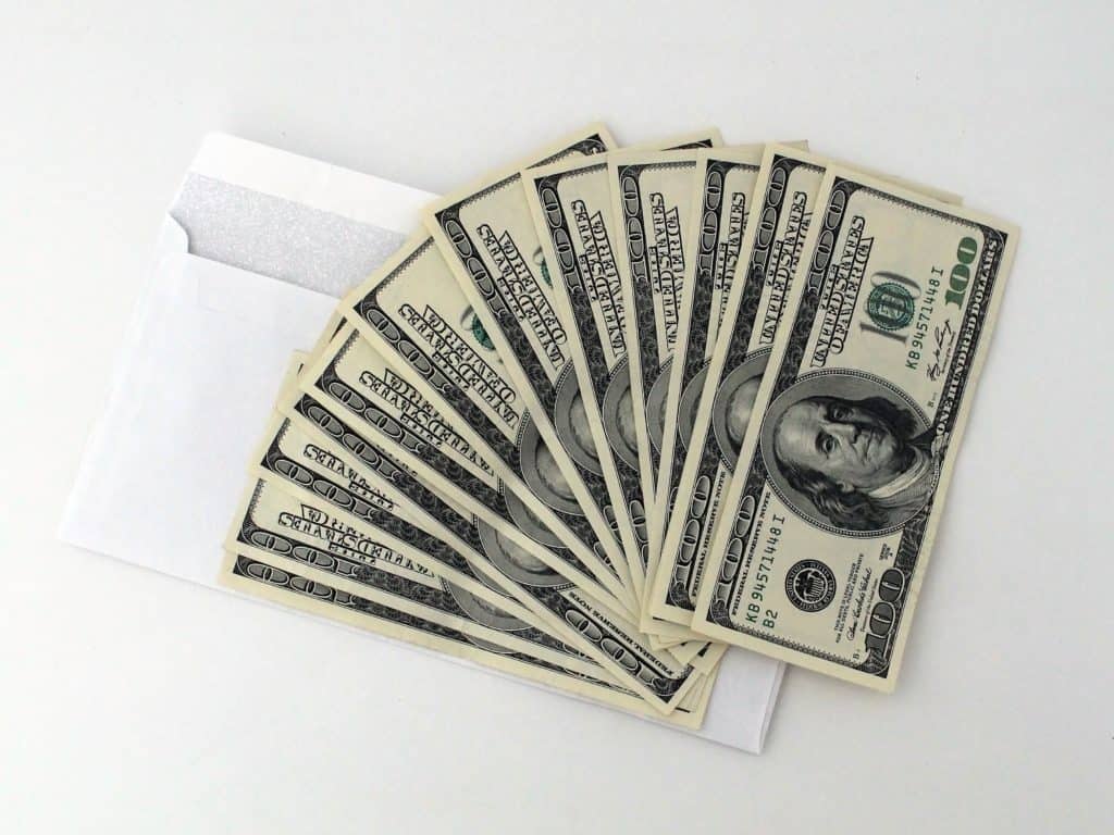 cash spread out on a white envelope - cash envelope system