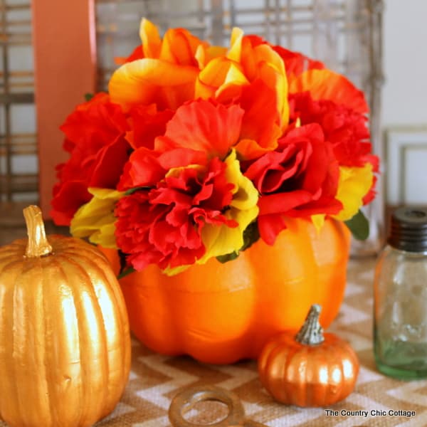 orange pumpkin with orange flowers fall diy decor