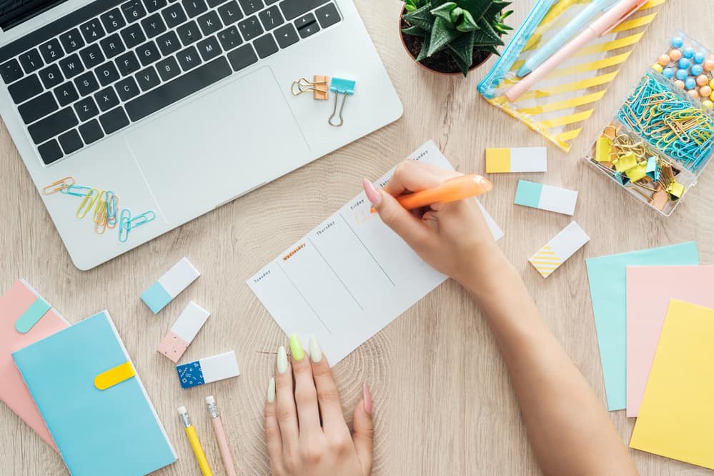 hands and stationery on desk 