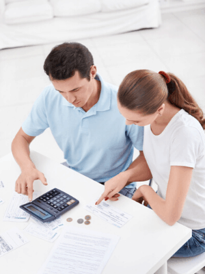 couple calculating 50-30-20 budget categories