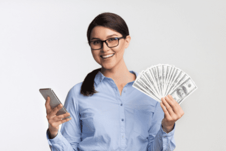 lady with cash and phone - get paid to watch ads