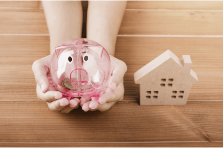 piggy bank and house on table