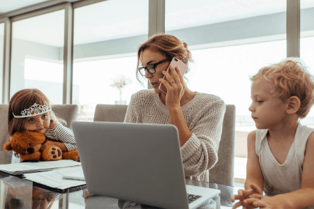 woman on laptop with kids around