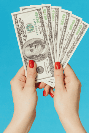 female hands holding cash