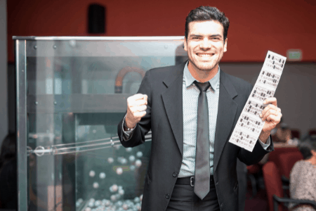 man holding winning lottery ticket