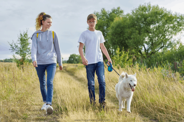 teens walking a dog