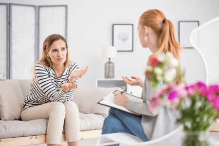 I don't want to go to work - woman talking to other woman on couch