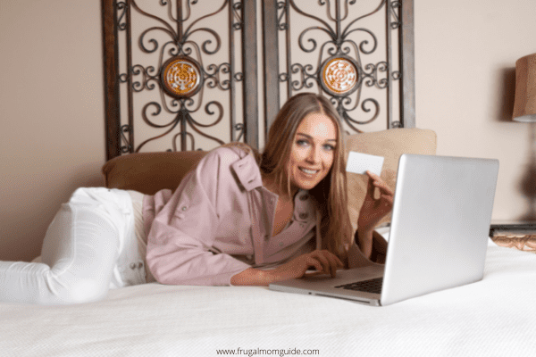 woman with gift card to sell on laptop