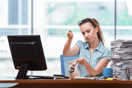 how to become a millionaire overnight - lady with money bag at desk