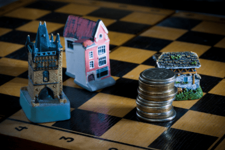 how to become rich with real estate - chess game with houses and money