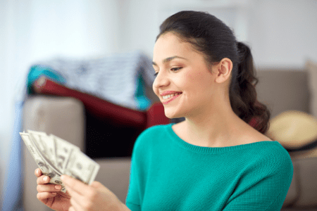 Get 100 dollars now - smiling woman with cash