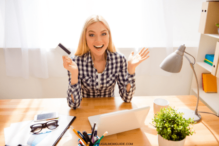 debit card suddenly being declined - happy lady with card and computer