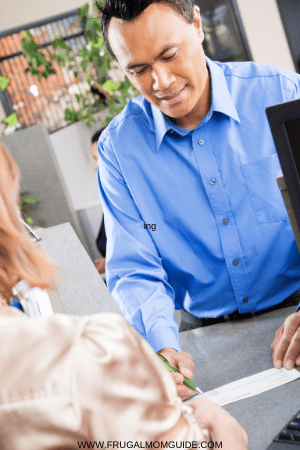 depositing a check - man with a check at a counter