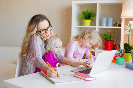 woman working from home with two kids