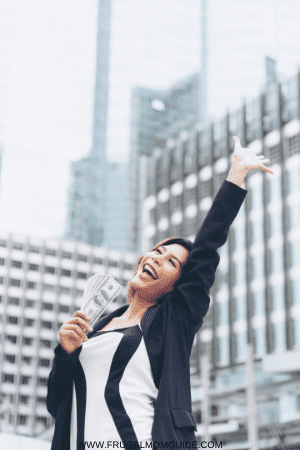 a good salary for one person - happy woman in city with money in her hands