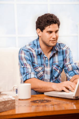 man doing surveys on laptop