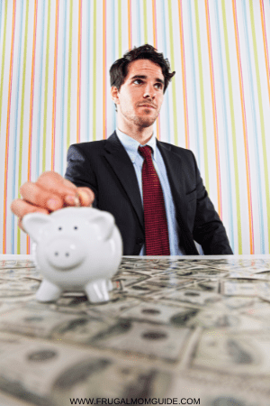 how much does a single person need to live on - nervous man with piggy bank