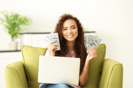 how to flip your money - woman with laptop and money 