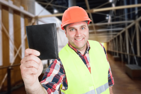 quick cash flips - man in hard hat holding up wallet