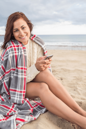 $2000 for free - woman on beach with phone