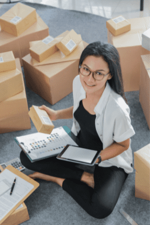 get $2000 free money now - woman with tablet and packages