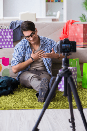 $2000 in free money - male vlogger sitting on floor with camera