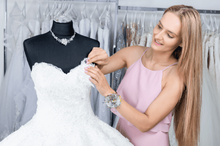 dress alterations near me - female tailor pinning a wedding dress - female tailor 