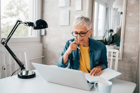 woman sitting by desk with laptop