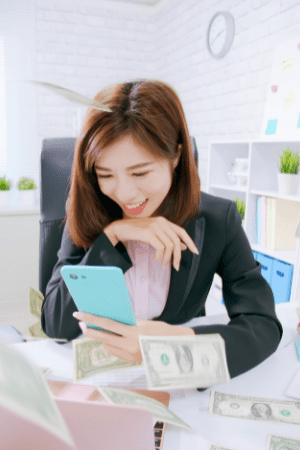 cash app flips proof - woman in business suit smiling at cell phone