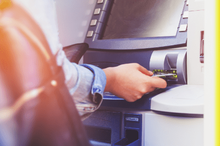 person using coinstar kiosk