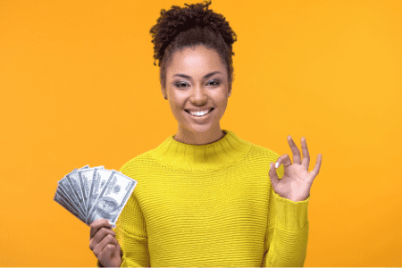 happy woman holding cash