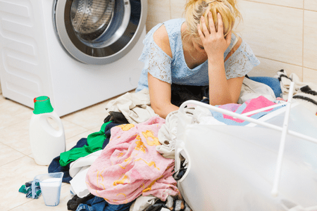 closest laundromat - frustrated woman sorting laundry