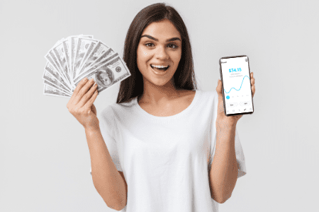 woman holding phone with money