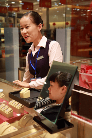 nearest pawn shop near me - woman at pawn shop looking at jewelry