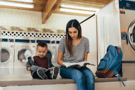 washaterias near me - young woman and her son reading at laundry