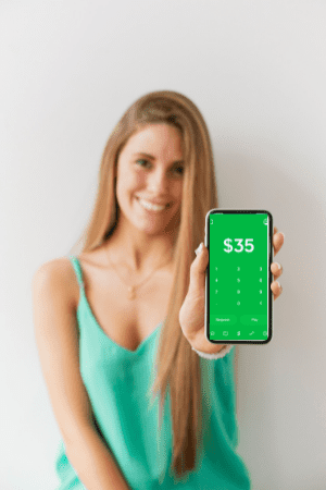 woman holding phone with cash app screenshot