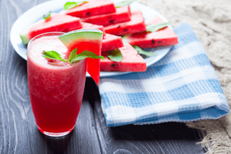 summer watermelon drink in glass with watermelon wedge