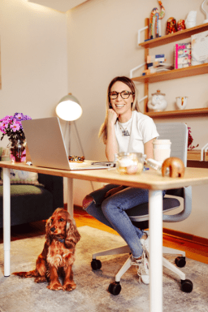 woman at home desk with dog