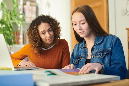 woman tutoring as a teacher with teenaged girl