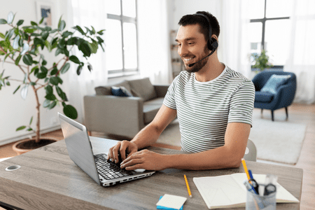 man with headset and laptop working to earn $3000 fast